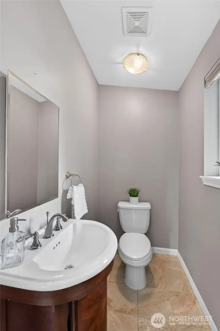 Tile flooring and a beautiful vanity are featured in the loft 1/2 bath Tile flooring and a beautiful vanity are featured in the loft 1/2 bath