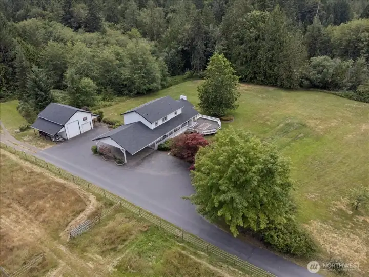 2.29 level, lush acres featuring fruit trees (3 apple and a plum) large garage and multiple carports.