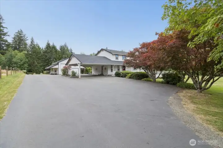 Stunning farmhouse with acreage, lots of parking, a huge garage, WOW!