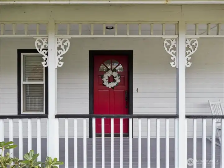 Covered front porch with new balusters, fresh paint and expansive covered deck.
