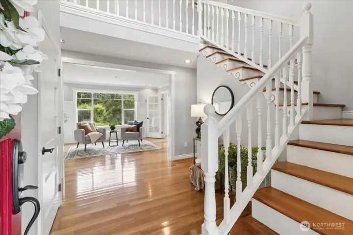 Gracious Foyer with vaulted ceilings, hardwood floors and lovely natural light throughout the home.