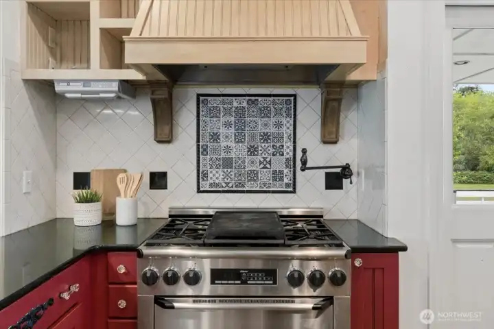 Custom tilework, gas range, pot filler.