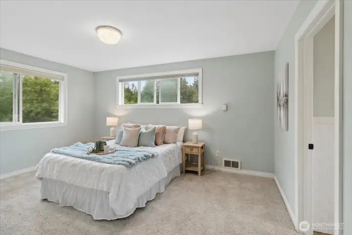 Upstairs: Primary bedroom features ensuite bath and dual closets...