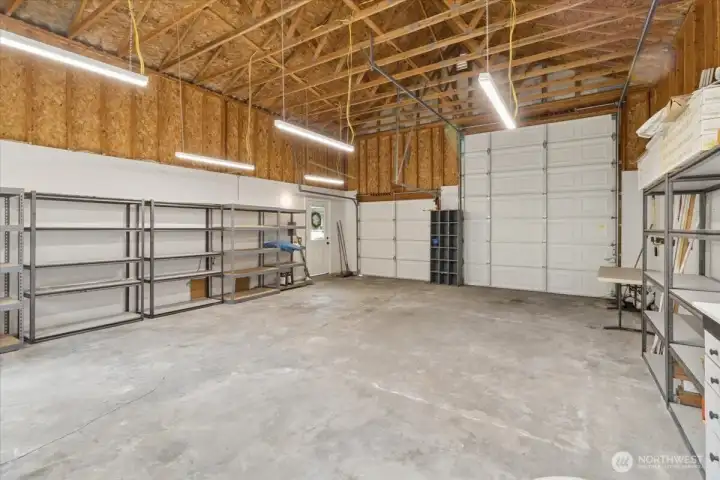 Incredible garage with built in work bench and lots of storage shelving!