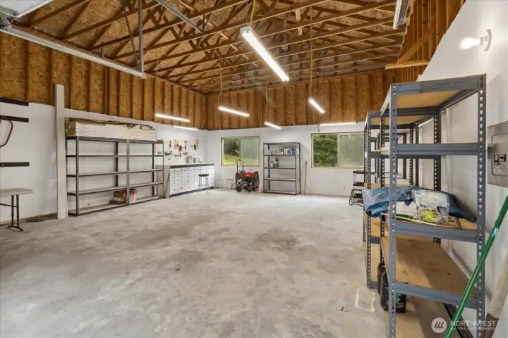 Inside the amazing garage. Storage racks stay! Riding mower negotiable.