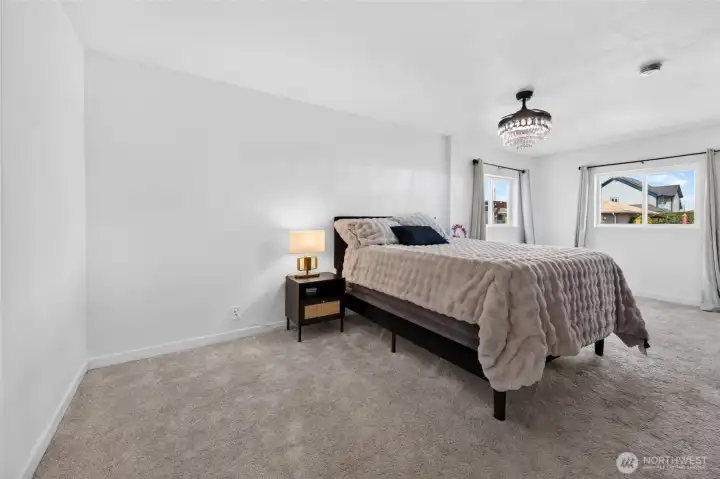 Primary Bedroom: Relax in this huge primary bedroom. The beautiful ceiling fixture is a light and ceiling fan.
