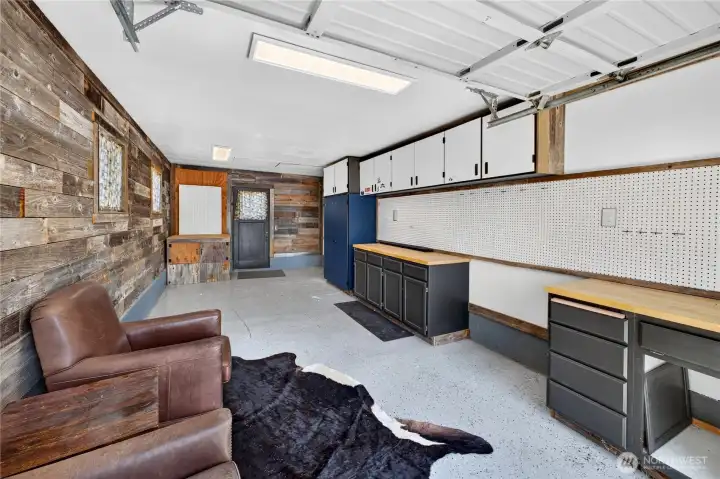 Garage: Currently used by owners as a workshop and hangout space. Built in cabinets provide a great work space and the barn boards add to the rustic charm.