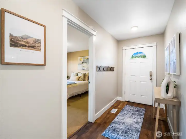 A welcoming foyer featuring beautiful laminate flooring that adds warmth, style, and lasting appeal. A welcoming foyer featuring beautiful laminate flooring that adds warmth, style, and lasting appeal.