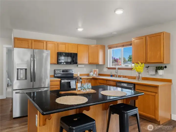Bright and inviting, this spacious kitchen is filled with natural light and offers plenty of counter space for meal prep, casual dining, and gathering. Bright and inviting, this spacious kitchen is filled with natural light and offers plenty of counter space for meal prep, casual dining, and gathering.