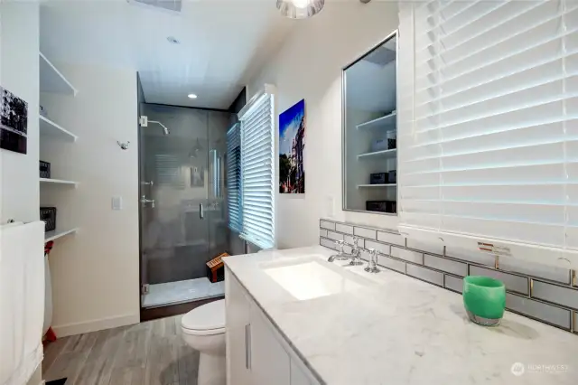 Primary bathroom with heated tile floors that extend into the shower.