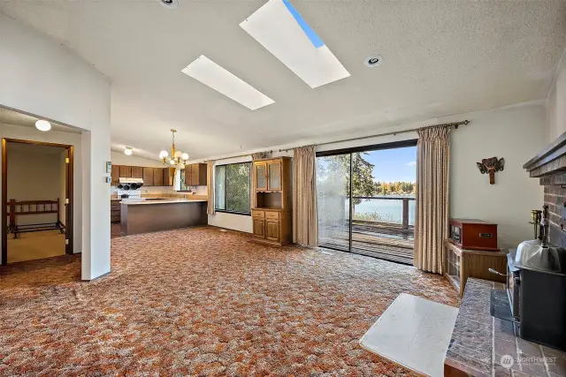 Main Floor - Living Area and Kitchen. Sliding Glass Door Open to Decking.