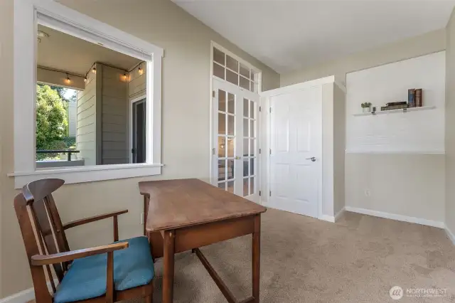 Additional view of bedroom with a built in shelf/accent wall and closet