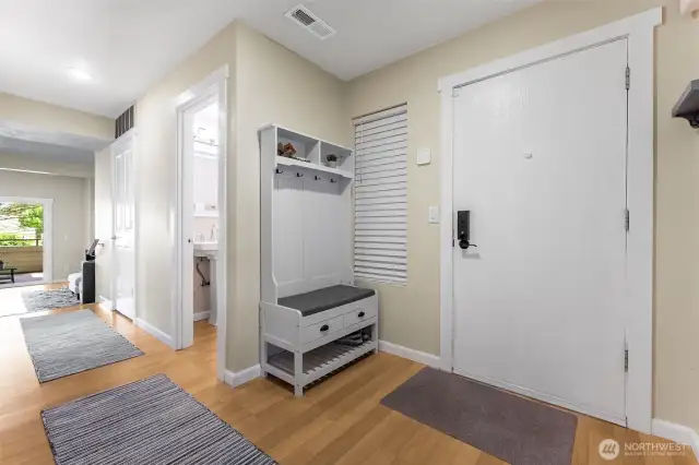 Inviting entry with a storage closet to the right and to the left is the updated half bath