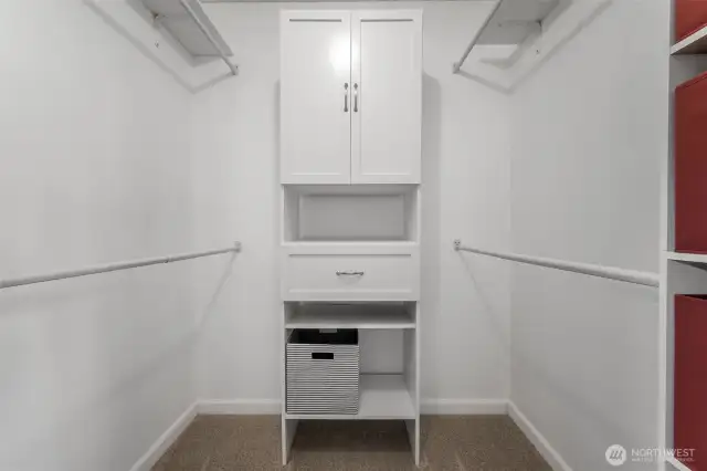 Primary walk-in closet with custom shelving