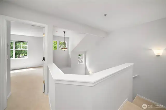 Upstairs hallway connecting two spacious primary suites