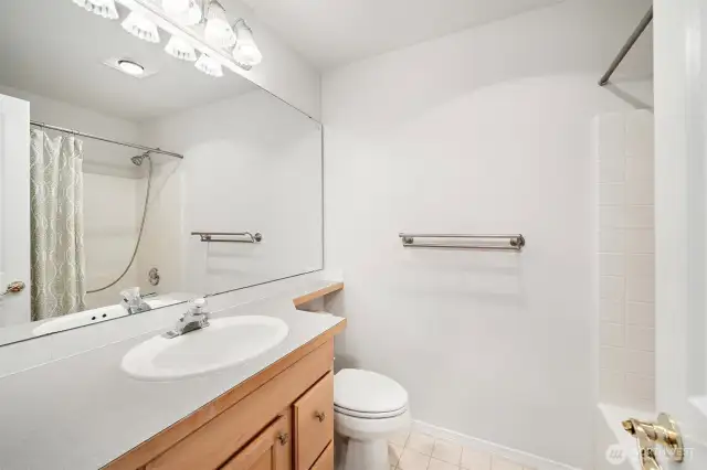 The second primary en-suite features a full bath with a spacious vanity and shower. Perfect for guests or multi-generational living
