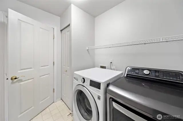 Functional laundry area featuring wire shelves and linen storage