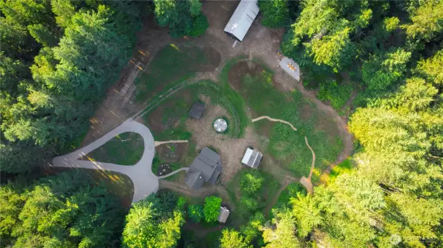 Aerial of the meadow, barn, original farmhouse, sleeping cabin, potting shed and woodshed.