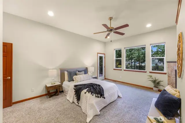 Primary bedroom has a french door entrance, walk-in closet, en-suite bathroom and a door to the deck.
