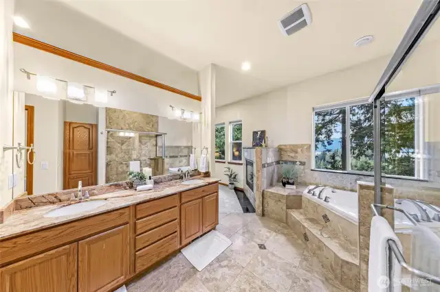 Double sink vanity with granite countertops and great views from the shower.