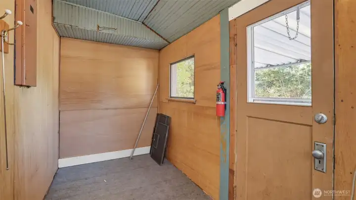 Versatile space off of kitchen that's ideal for storage. Leads to back deck.