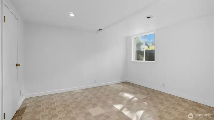 One of two full-height bedrooms downstairs. Notice the large window well for proper egress.