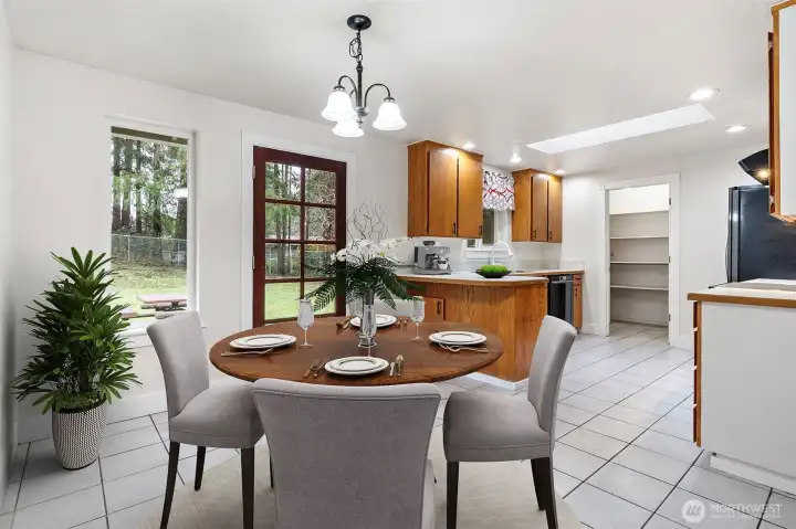 Cute kitchen with surprisingly great storage, including a walk-in pantry. Space for a dining table and bar seating. (Virtual staging)