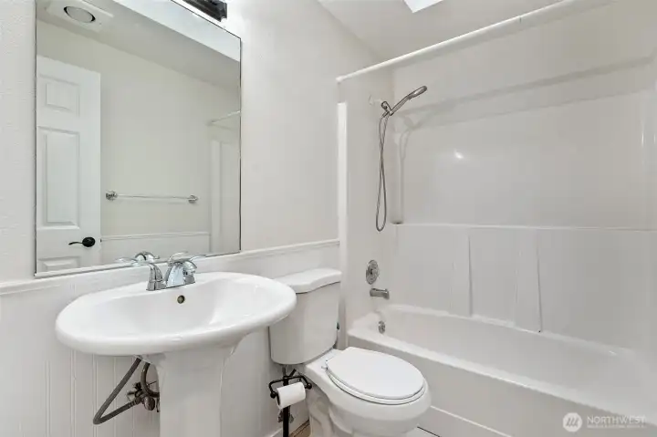 Light and bright main bathroom.