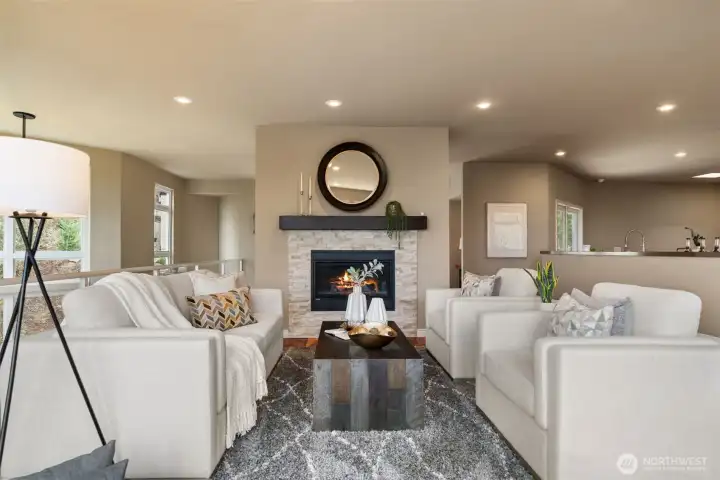 Open living room with custom gas fireplace and stacked stone.