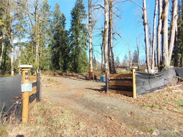 Front gate into parking area and clearing