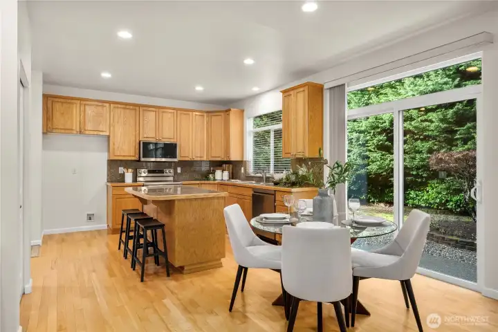 The kitchen is open to the casual dining area with a slider that leads to the patio and backyard.