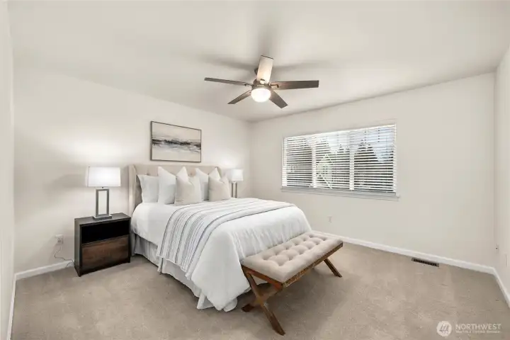 The primary bedroom is a peaceful setting designed for rest and relaxation.