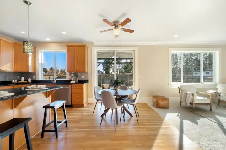 Central open kitchen with informal dining area and bar seating
