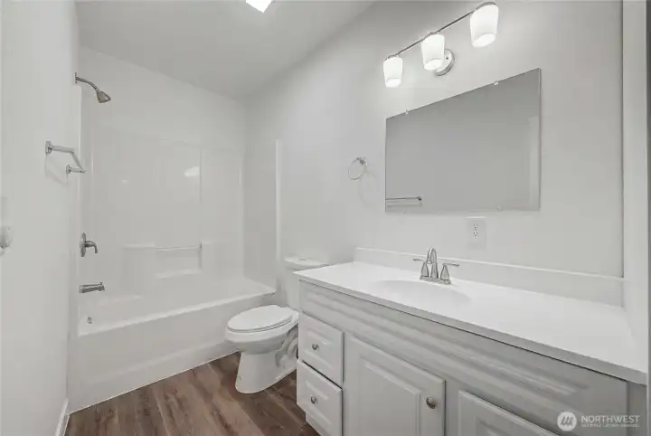 Beautiful bathroom with lots of storage. Virtually staged, removed items from counter.