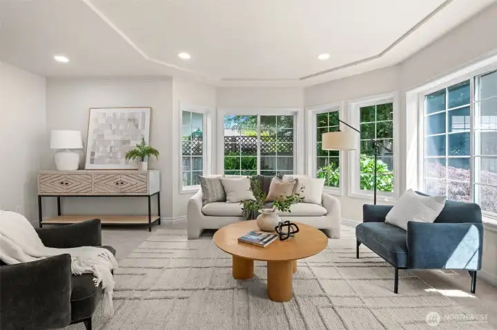 The living room combines abundant natural light, architectural detail, and flexible space for everyday living.