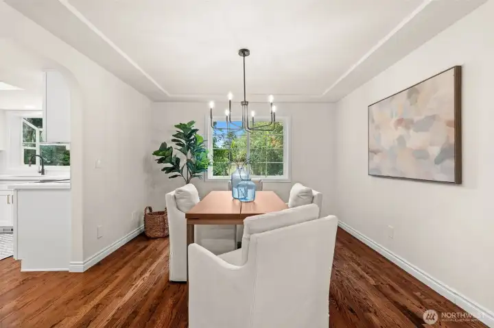 Tray ceiling and large window enhance the character and ambiance of this dining room.