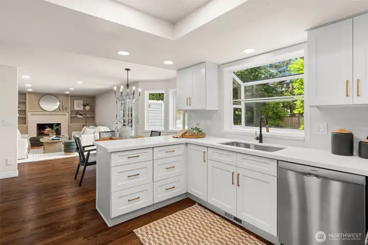 Open-concept kitchen offers seamless connection to the dining and family rooms, creating an ideal space for gathering and entertaining.