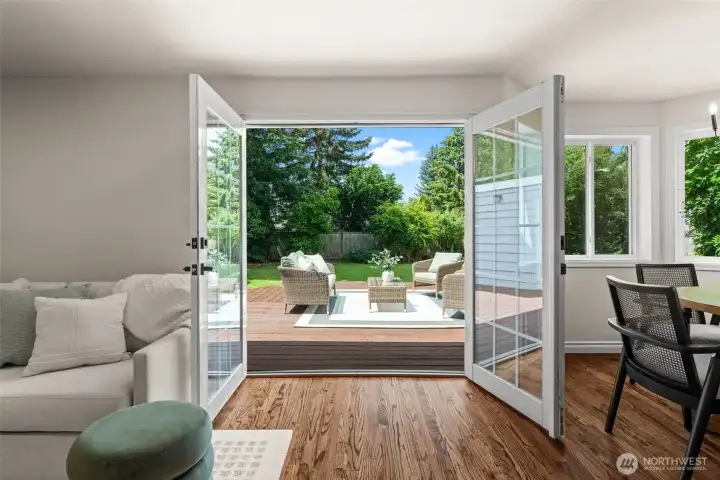 The refinished hardwood floors tie seamlessly with the wood deck and backyard that are just steps away, creating a natural extension of the home's living areas.