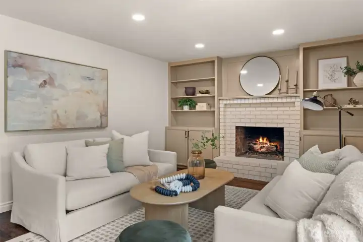 The fireplace creates a natural focal point adding warmth and ambiance and is complemented by custom built-ins and recessed lighting.