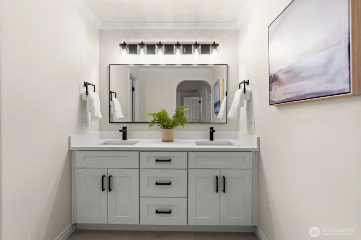 Spacious bathroom vanity features dual sinks, quartz counters, and generous cabinet storage.