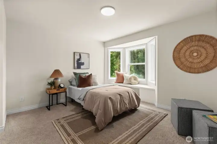 One of two secondary bedrooms features a bay window with built-in seating and a flexible layout for a variety of needs.