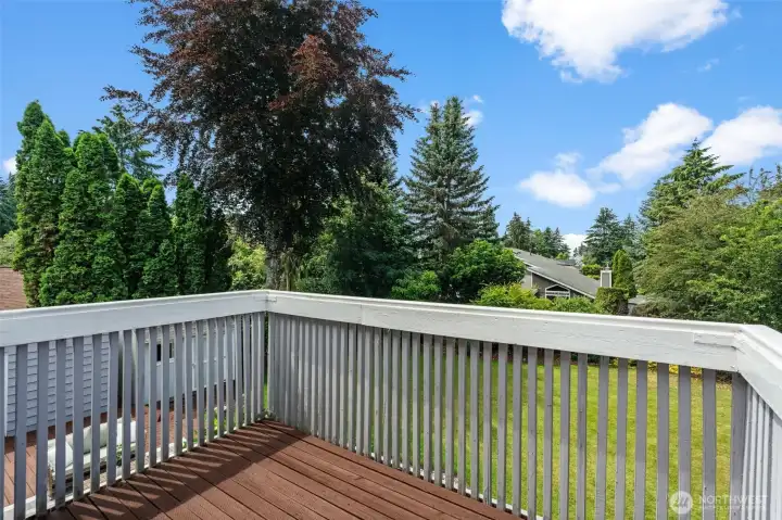 Enjoy views of mature trees and open lawn space from this private deck area.