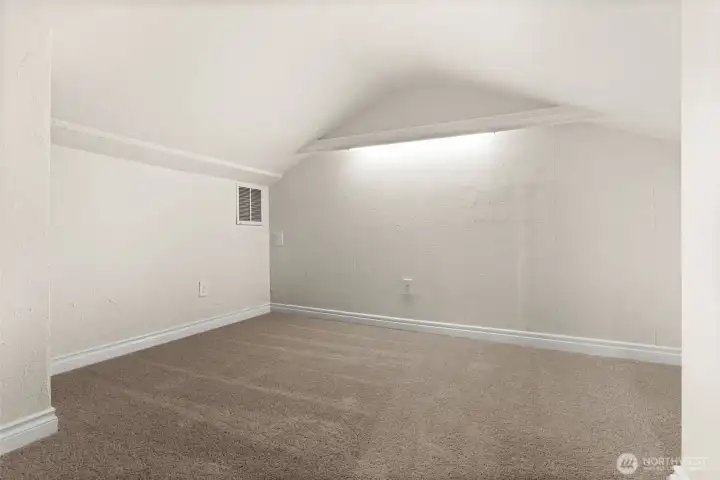 Additional finished room provides versatile square footage with built-in lighting and carpeted flooring.
