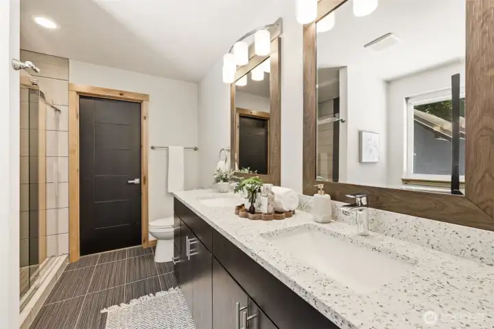 The large primary bath features a double vanity, sitting area and a large walk-in shower