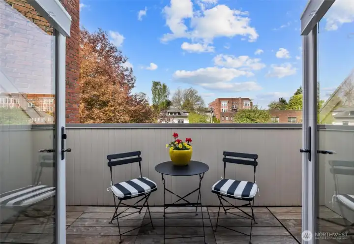 French doors open from the main living area to one of two private balconies.