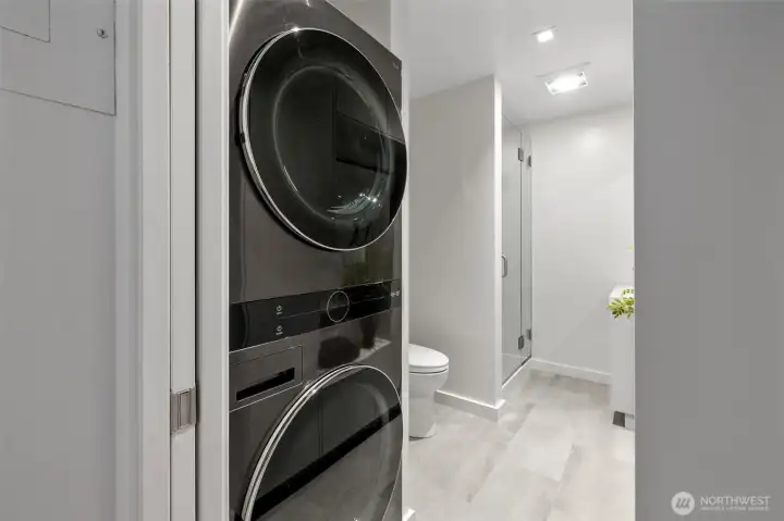 Remodeled main-floor 3/4 bathroom with newer LG washer/dryer duo.