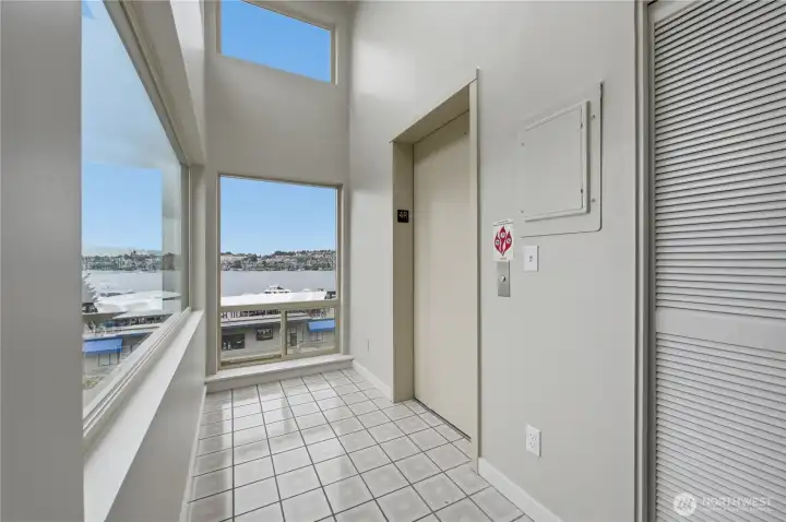 Your formal entry foyer with elevator to your front door & soaring ceilings, walls of windows to soak in the Lake Union views! Your formal entry foyer with elevator to your front door & soaring ceilings, walls of windows to soak in the Lake Union views!