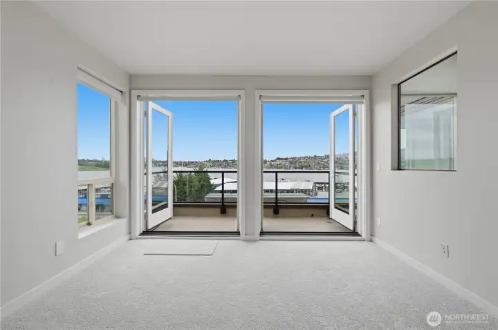 French doors in your dramatic sunken living room with wood burning fireplace, wet bar & private deck to enjoy the Lake Union views! French doors in your dramatic sunken living room with wood burning fireplace, wet bar & private deck to enjoy the Lake Union views!