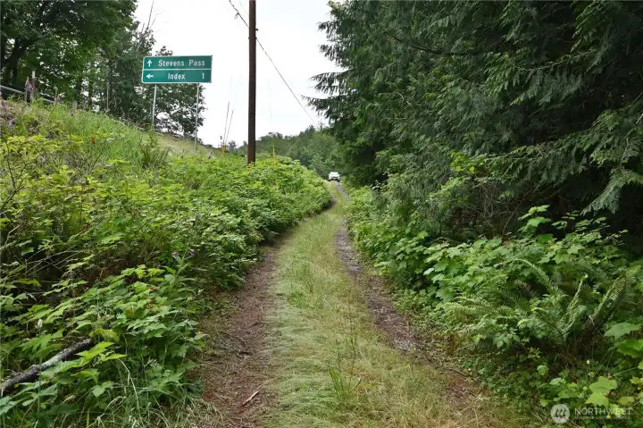 Access road ~ very lightly used.  Closer to cabin, road is overgrown w/old rock base underneath. Foot path veers right to cabin entrance.