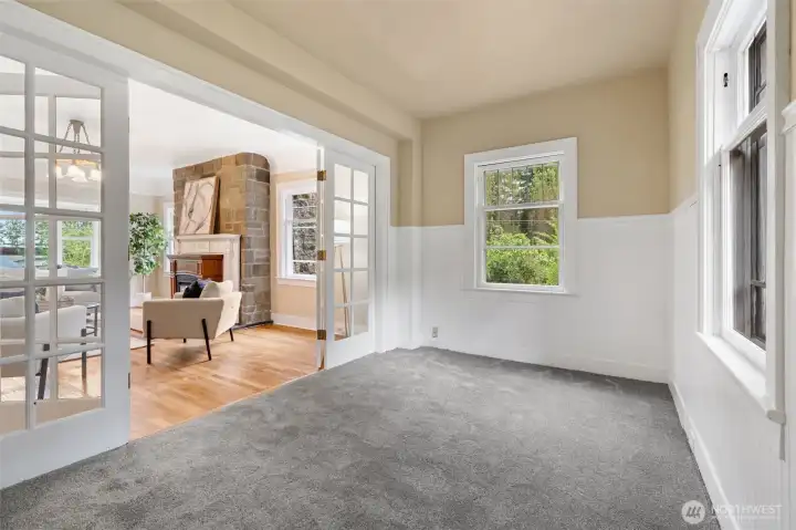 French doors separate side room with living room. French doors separate side room with living room.